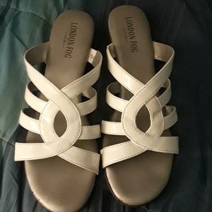 A pair of white London fall wedge sandals